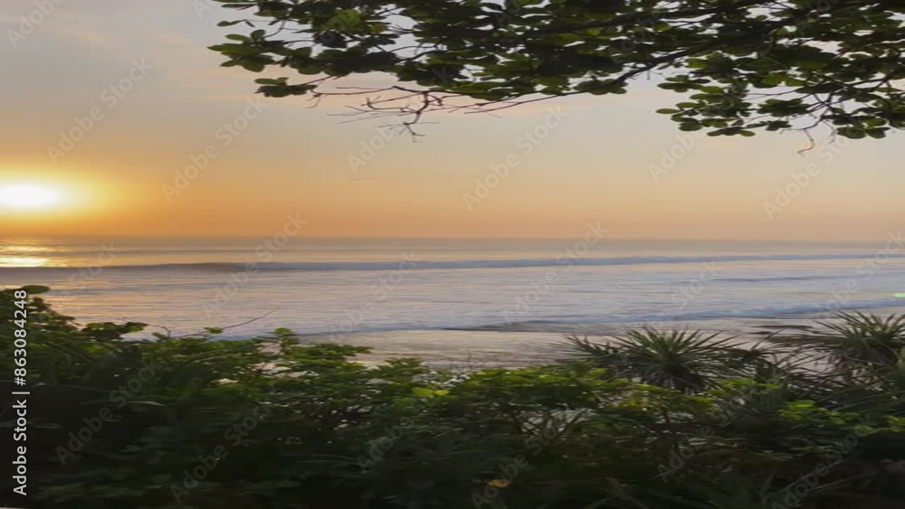 Amazing sunset in Bali, trees silhouetted against an orange sky. Amazing sunset in Bali, trees silhouetted against an orange sky.