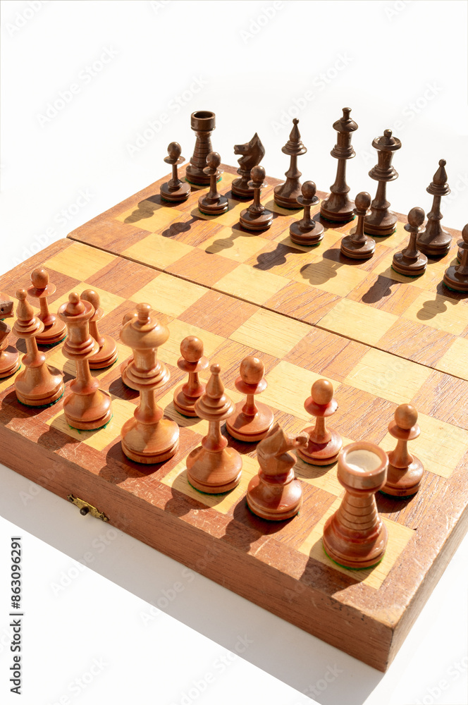 small portable wooden chess board on white background diagonally oriented small portable wooden chess board on white background diagonally oriented