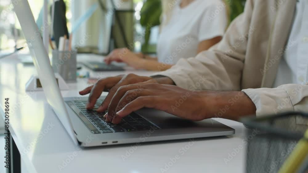Cropped shot of hands of unrecognizable managers filling form on computer when sitting at office desk Cropped shot of hands of unrecognizable managers filling form on computer when sitting at office desk
