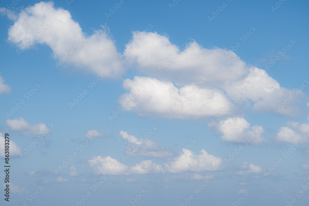 Scattered white clouds in a clear blue sky Scattered white clouds in a clear blue sky