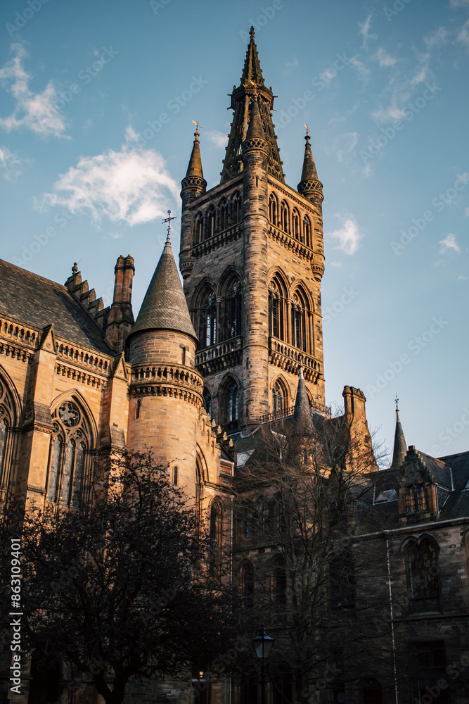 Fototapeta premium A tall building with a clock tower on top, standing majestically against the sky