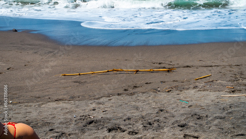 BALI MARCH 2024 - beautiful girl on Seseh isolated beach is one with black sand in Bali, Indonesia photo