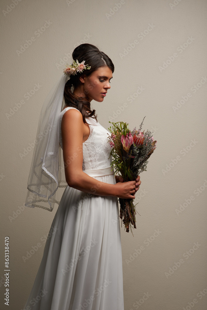 Wedding dress, woman and flowers in studio with style, cosmetics and mock up by wall. Bride, fashion and thinking of future for marriage, designer bridal gown and luxury for elegance and bouquet Wedding dress, woman and flowers in studio with style, cosmetics and mock up by wall. Bride, fashion and thinking of future for marriage, designer bridal gown and luxury for elegance and bouquet