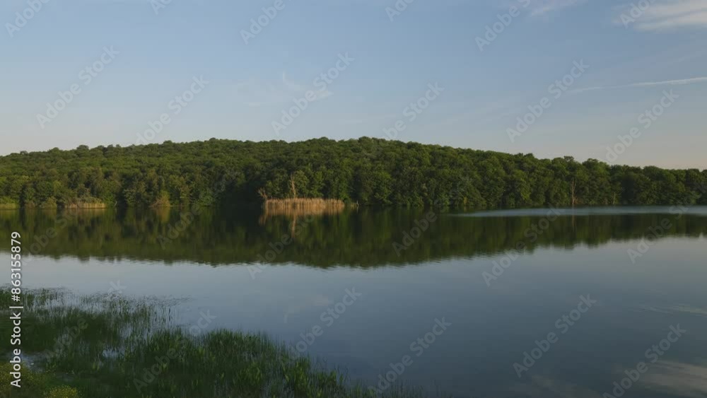 A peaceful lake view. Forests, plants and sky are reflected in the water. Stagnant drinking water reservoir. 4k video A peaceful lake view. Forests, plants and sky are reflected in the water. Stagnant drinking water reservoir. 4k video
