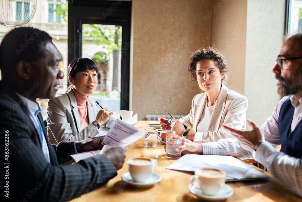 Business meeting in a cafe with diverse professionals Business meeting in a cafe with diverse professionals