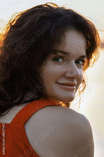 portrait of young beautiful long-haired brunette woman in contrasting sunset light