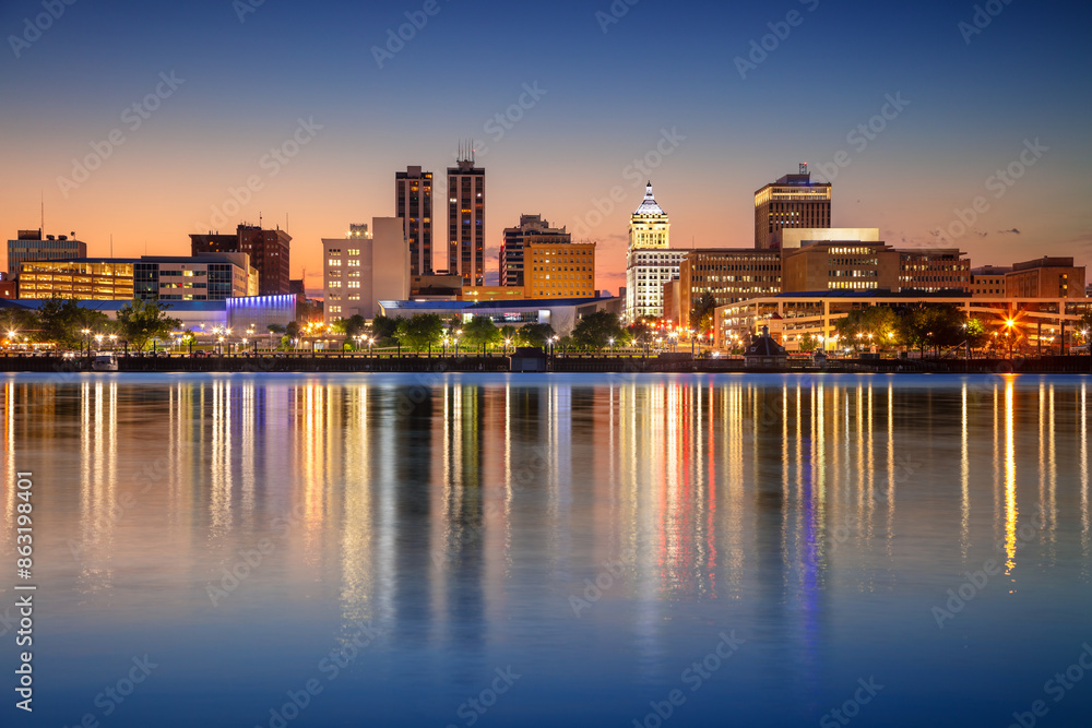 Peoria, Illinois, USA. Cityscape image of Peoria skyline, Illinois, USA with reflection of city lights in the Illinois River at twilight blue hour.