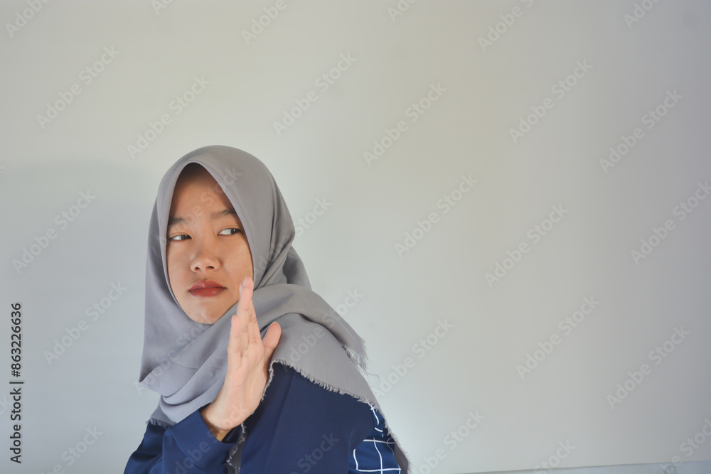 Stop. Concerned Asian woman showing refusal sign, saying no, raise awareness, standing over background Stop. Concerned Asian woman showing refusal sign, saying no, raise awareness, standing over background