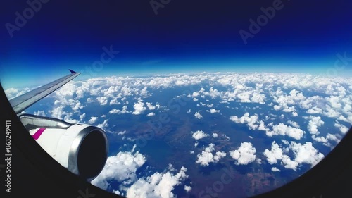 A breathtaking view of the world beneath and swiftly drifting clouds as seen from an airplane window during a journey
A breathtaking view of the world beneath and swiftly drifting clouds as seen from 