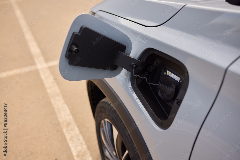 Naklejka premium The electric vehicle charging port is available for use and ready to be plugged into