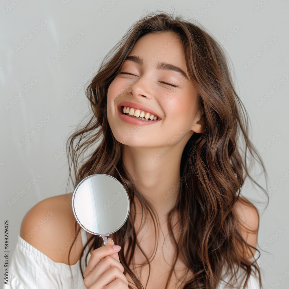 A beautiful young woman with wavy hair holding a small mirror, embracing her natural beauty with a radiant smile A beautiful young woman with wavy hair holding a small mirror, embracing her natural beauty with a radiant smile