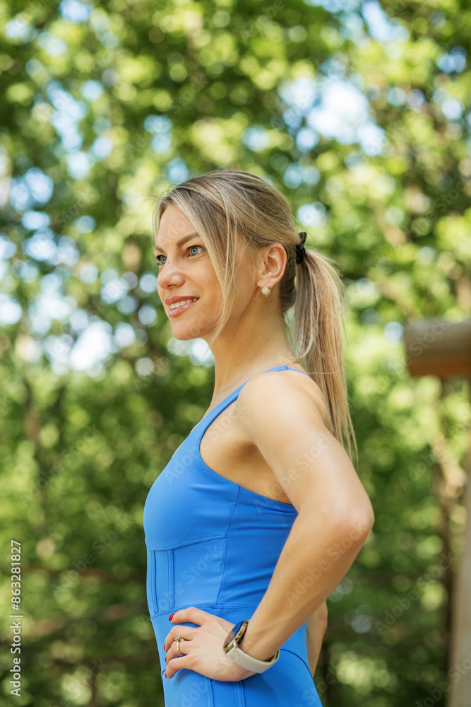 Confident Woman in Blue Sportswear Outdoors Confident Woman in Blue Sportswear Outdoors
