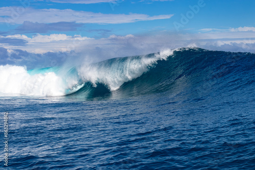 Monster waves at Teahupoo, Tahiti, French Polynesia - a world famous spot for surfing championships. The village of Teahupoo is known as “The end of the road” because the road from Papeete ends there.
