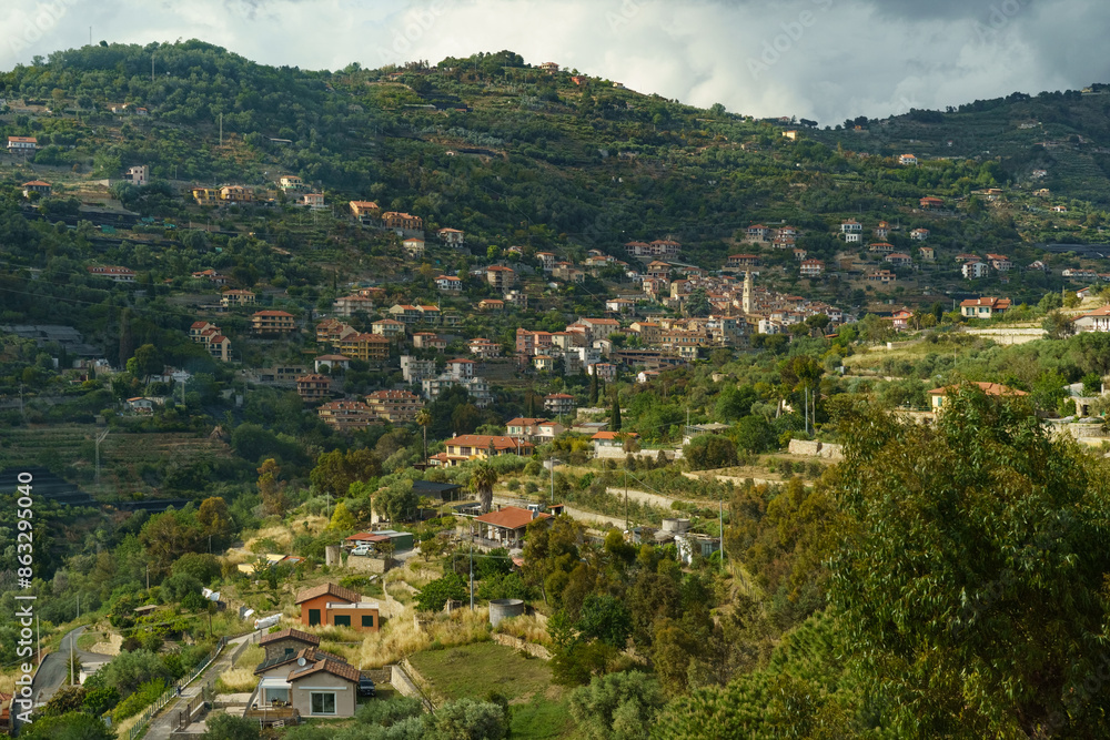 A Picturesque Village Nestled Among Rolling Hills on a Cloudy Day A Picturesque Village Nestled Among Rolling Hills on a Cloudy Day