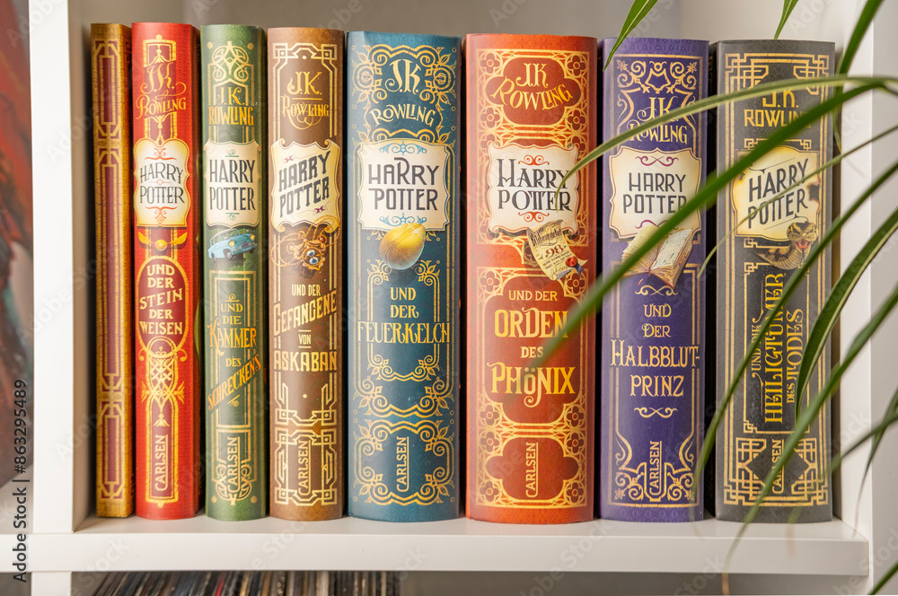 Fototapeta premium J.K. Rowling's Harry Potter books in various editions, evoking sense wonder and excitement for readers all ages, and celebrating power imagination and storytelling, Frankfurt - December 22, 2023