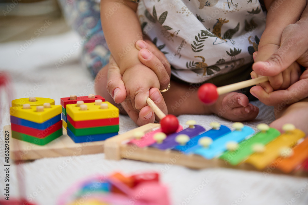 Parent and child playing with colorful educational toys Parent and child playing with colorful educational toys