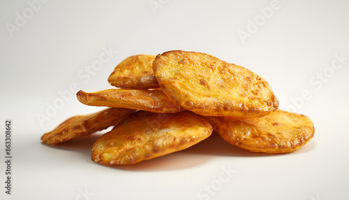 Roasted potatoes. Baked potato wedges in frying pan on white background.