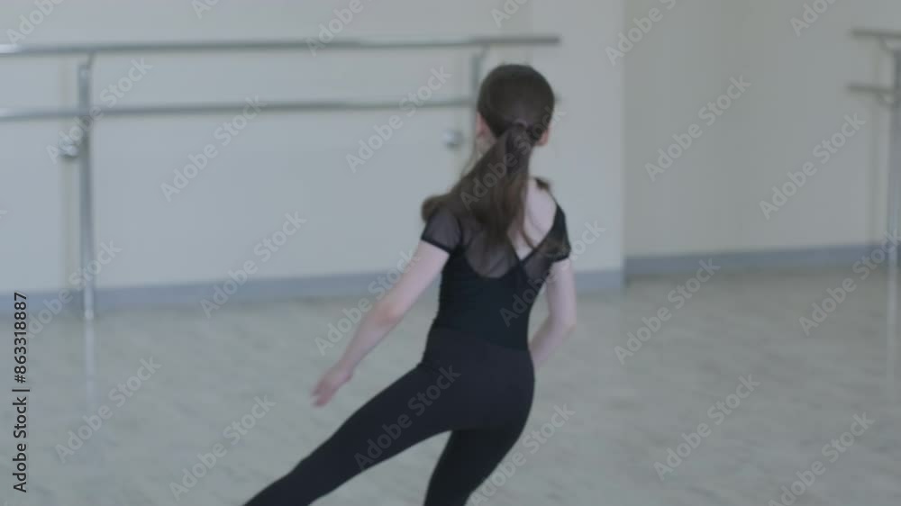Young Ballerina Practicing Dance Moves in Studio Young Ballerina Practicing Dance Moves in Studio