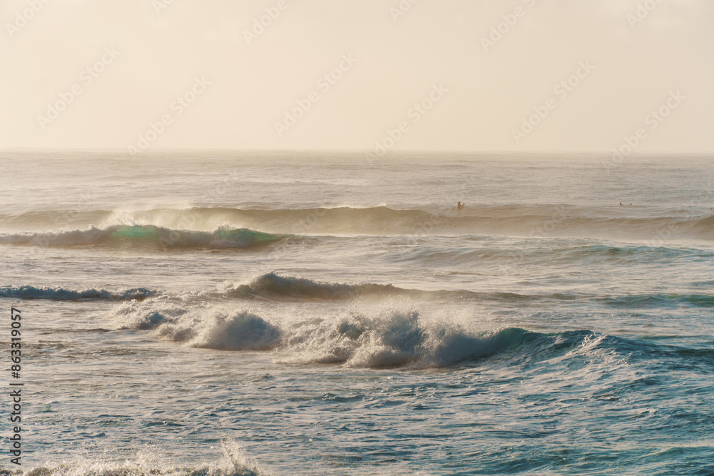 A slightly outoffocus image of waves breaking on a sandy shore A slightly outoffocus image of waves breaking on a sandy shore