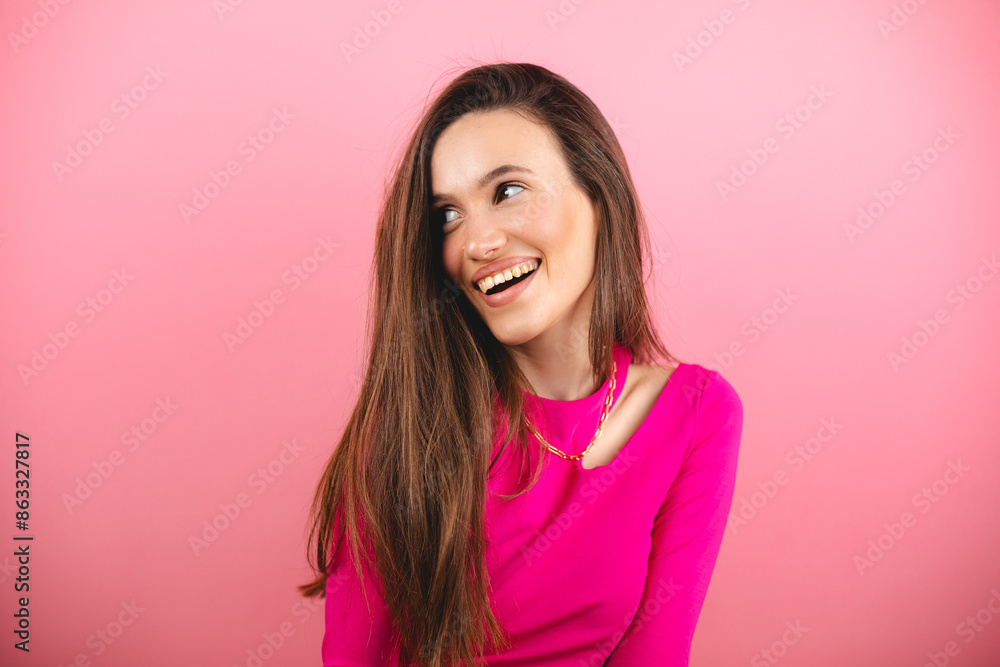 Happy cheerful young woman wearing pink long sleeves top rejoicing at positive news or birthday gift, looking at camera with joyful and charming smile. Brunette student girl isolated pink look at side Happy cheerful young woman wearing pink long sleeves top rejoicing at positive news or birthday gift, looking at camera with joyful and charming smile. Brunette student girl isolated pink look at side
