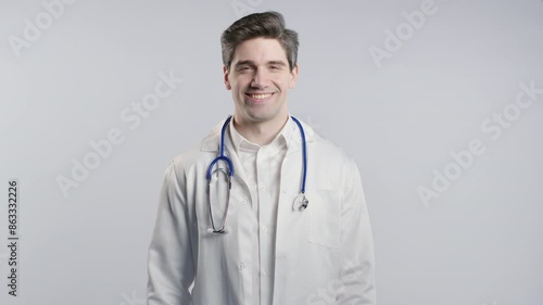Doctor showing yes signal, nods head, approve. Positive agreed man on white