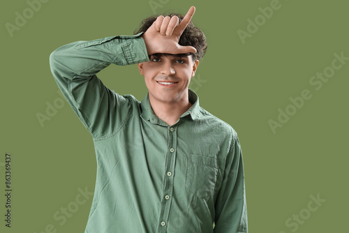 Young man showing loser ges...