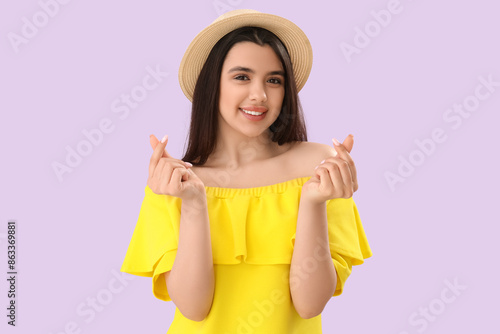Young woman making heart wi...