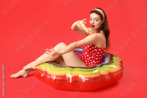 Young woman with swim ring ...