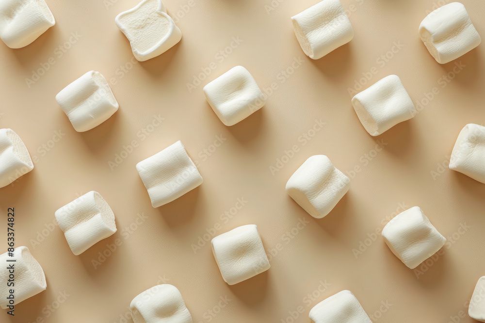 Sweet marshmallows arranged in rows on an isolated beige background top view
Sweet marshmallows arranged in rows on an isolated beige background top view