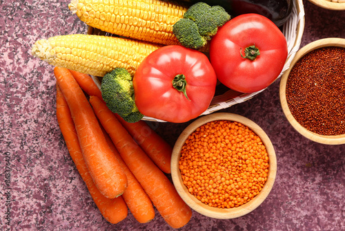 Wallpaper Mural Wicker bowl with different fresh vegetables and cereals on purple background Torontodigital.ca