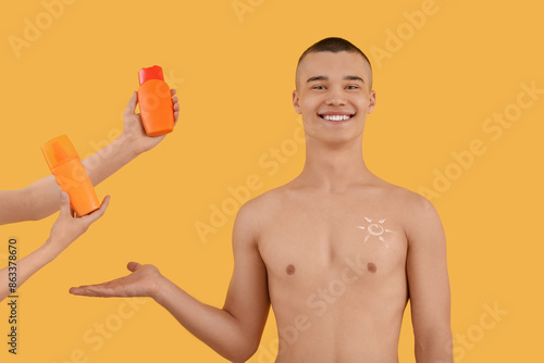 Happy young man pointing at...