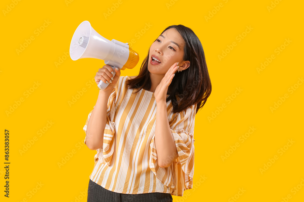 Beautiful Asian woman shouting into megaphone on yellow background. Dialogue concept Beautiful Asian woman shouting into megaphone on yellow background. Dialogue concept