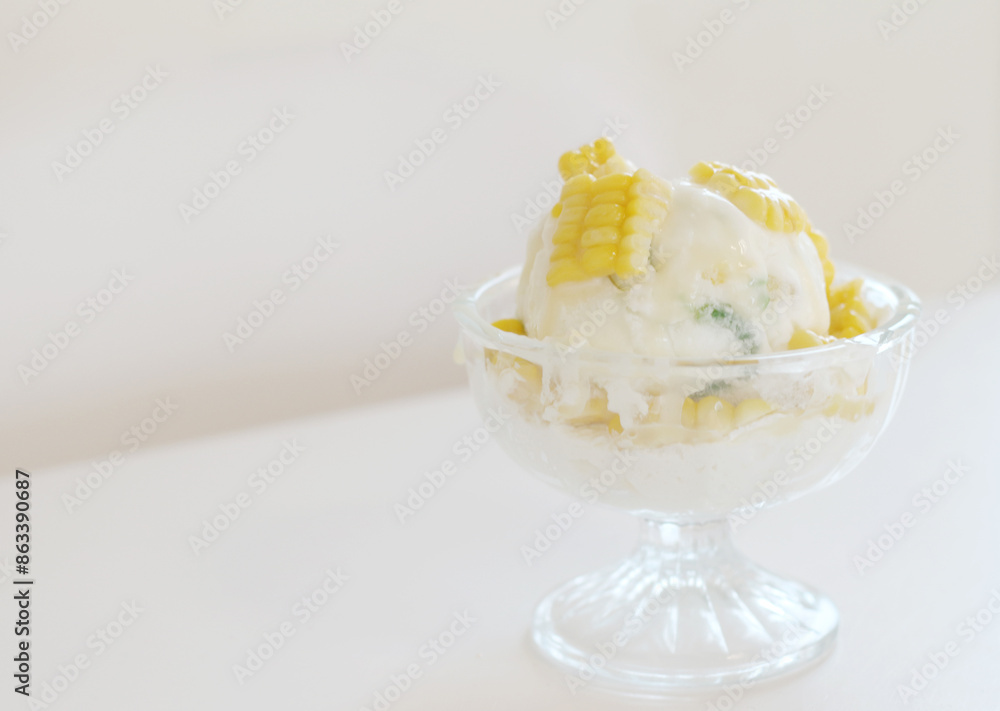 Corn ice cream in glass bowl on a table. Corn ice cream in glass bowl on a table.