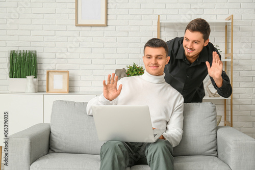 Young men with laptop video...