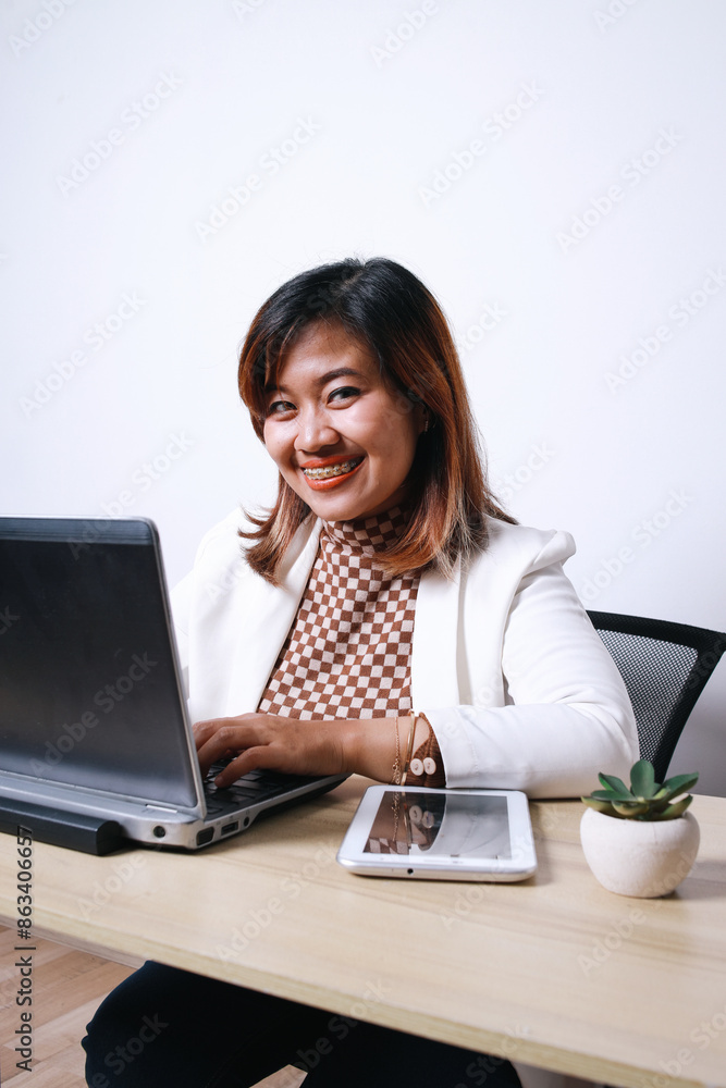Potrait Of Smiling Asian Dentist Female Using Laptop In Office. Dental Care Consultant Potrait Of Smiling Asian Dentist Female Using Laptop In Office. Dental Care Consultant