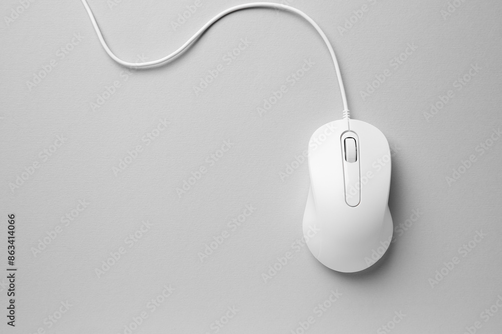 One wired mouse on grey background, top view. Space for text One wired mouse on grey background, top view. Space for text