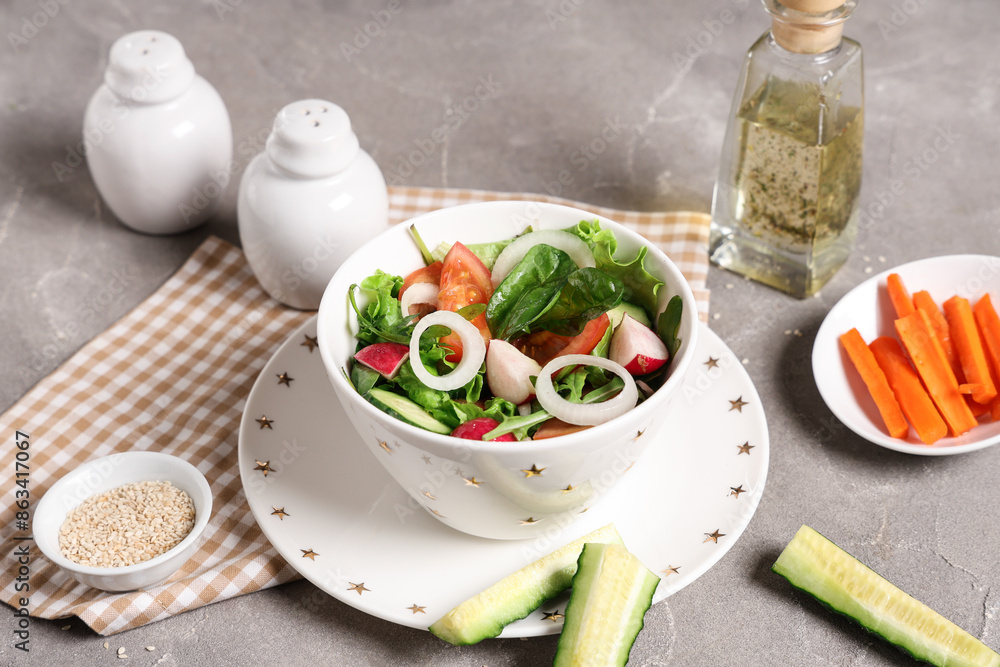 Bowl of fresh vegetable salad with tomato and cucumber on grey background Bowl of fresh vegetable salad with tomato and cucumber on grey background
