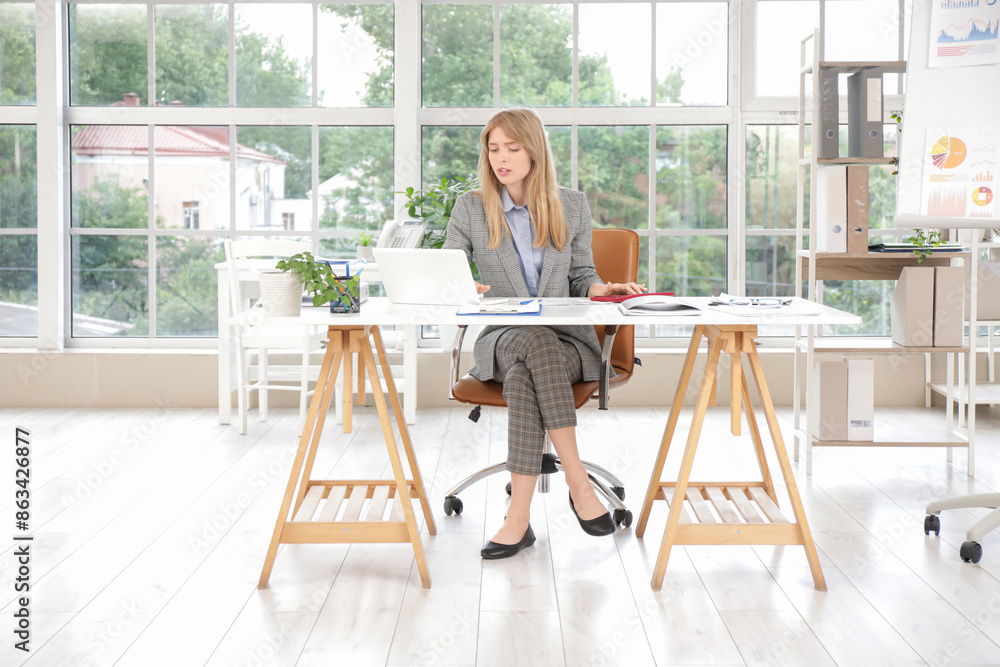 custom made wallpaper toronto digitalYoung female accountant working with calculator and laptop at workplace in office