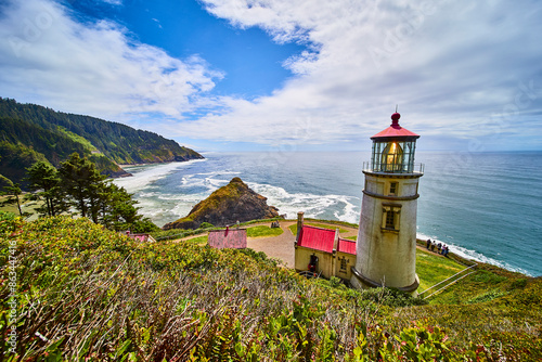 Heceta Head Lighthouse Overlooking Rugged Oregon Coastline at Golden Hour photo