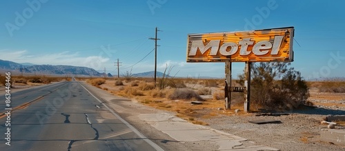 Rusty Motel Sign on a Desert Road