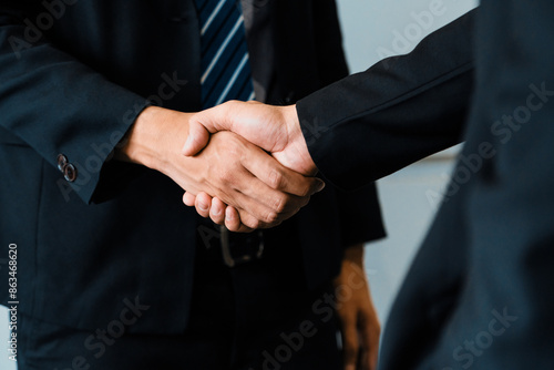 Business people agreement concept. Businessman do handshake with another businessman in the office meeting room. uds