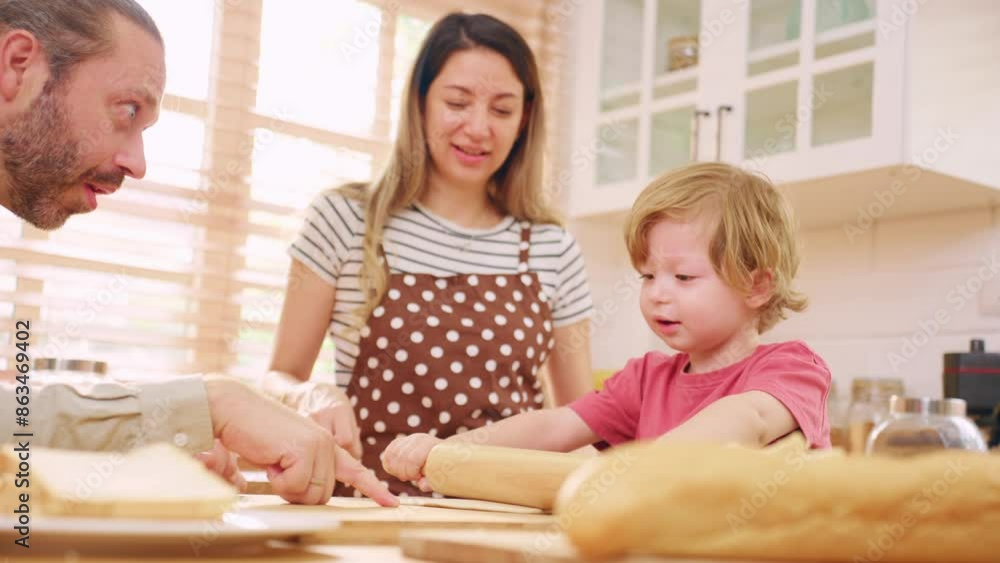 Caucasian attractive couple baking bakery with son in kitchen at home. Caucasian attractive couple baking bakery with son in kitchen at home.
