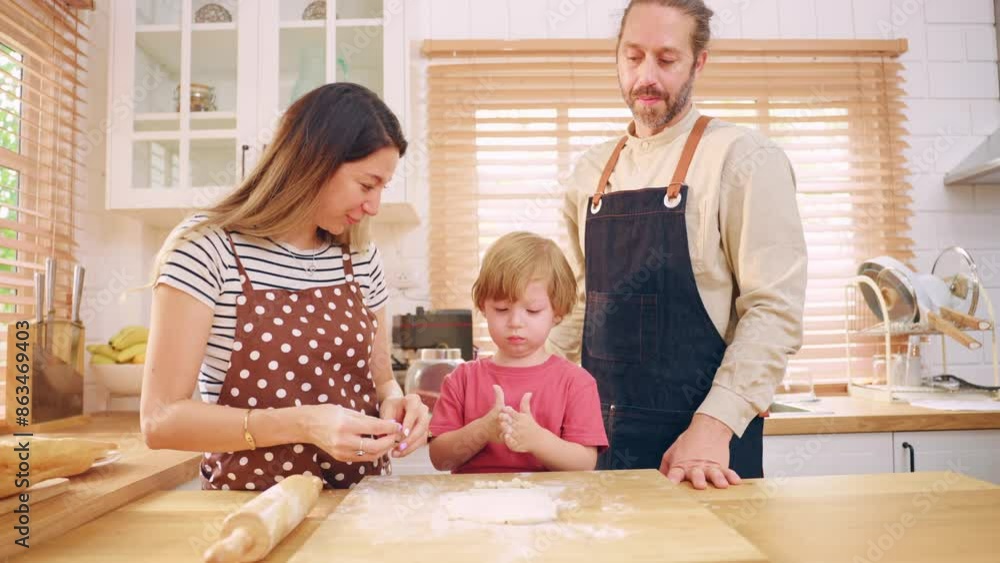 Caucasian attractive couple baking bakery with son in kitchen at home. Caucasian attractive couple baking bakery with son in kitchen at home.