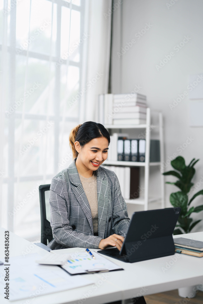 Confident Asian Business Woman Working on Laptop in Modern Office Environment Confident Asian Business Woman Working on Laptop in Modern Office Environment