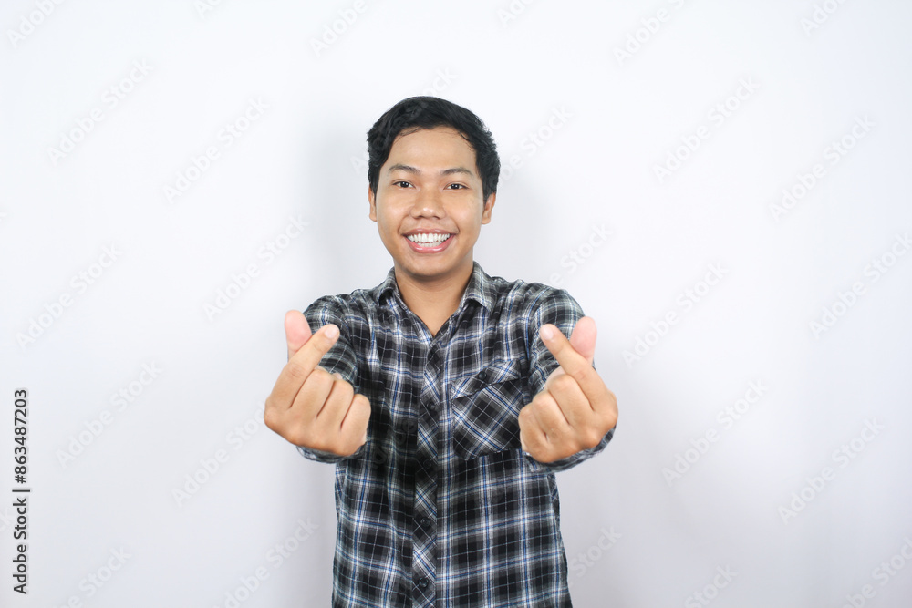 delighted asian man showing korean heart signs to camera with smiling face isolated delighted asian man showing korean heart signs to camera with smiling face isolated