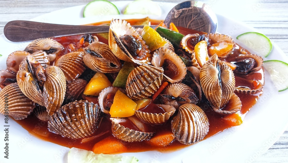 kerang asam manis. scallops boiled and drizzled with sweet and sour sauce. kerang asam manis. scallops boiled and drizzled with sweet and sour sauce.
