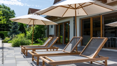 lounge chairs and umbrellas on the beach hotel © Paniti