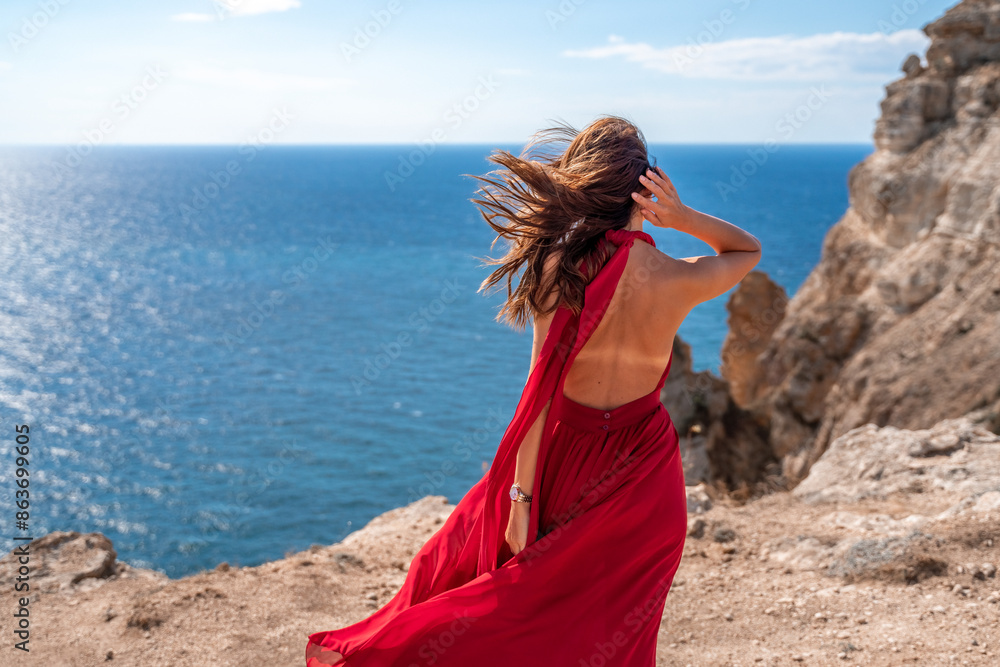 A woman in a red dress stands on a cliff overlooking the ocean. The scene is serene and peaceful, with the woman's dress adding a touch of elegance to the landscape. A woman in a red dress stands on a cliff overlooking the ocean. The scene is serene and peaceful, with the woman's dress adding a touch of elegance to the landscape.