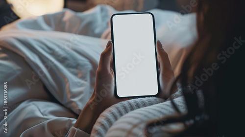 Woman using smartphone in bed