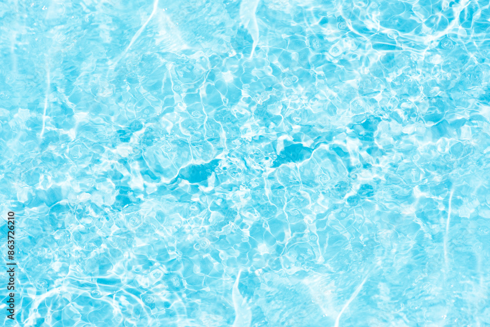 Blue water with ripples on the surface. Defocus blurred transparent blue colored clear calm water surface texture with splashes and bubbles. Water waves with shining pattern texture background. Blue water with ripples on the surface. Defocus blurred transparent blue colored clear calm water surface texture with splashes and bubbles. Water waves with shining pattern texture background.